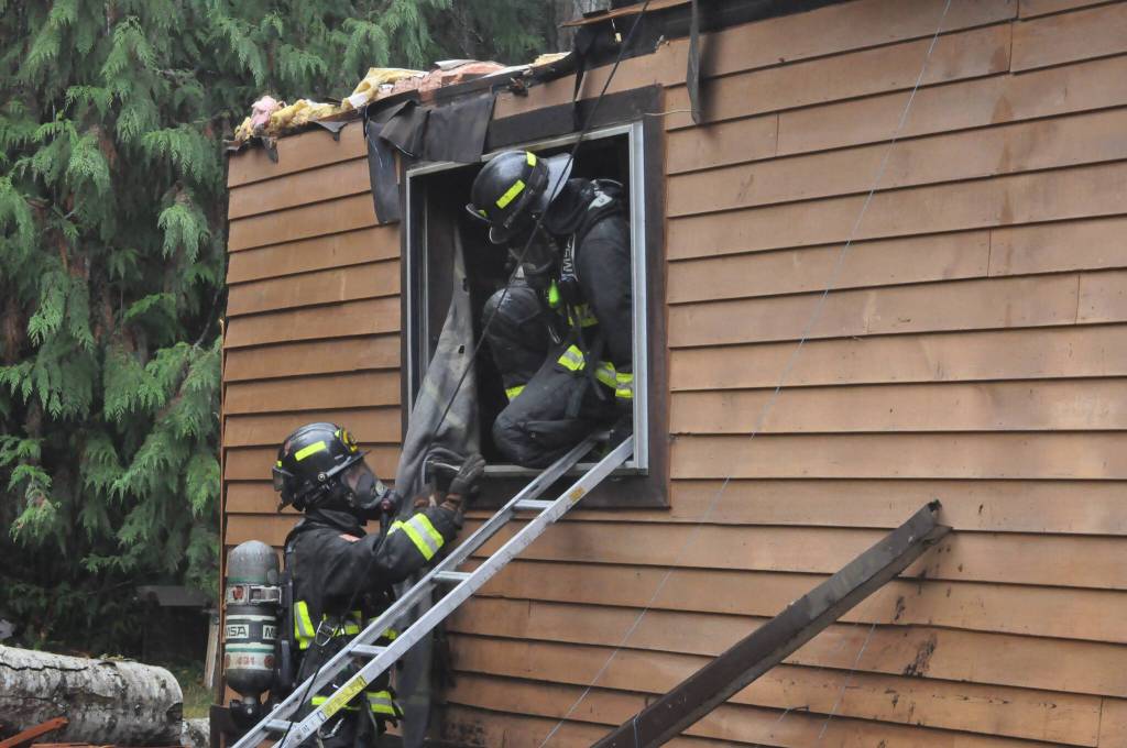 Sequim Gazette photo by Matthew Nash
Clallam County Fire District 3 firefighters climb out of a house fire on Nov. 12 on the 100 block of Barnes Road where a man was found deceased. His identity has not been released as an autopsy remains pending as of Nov. 18.