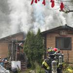 Sequim Gazette photo by Matthew Nash
Clallam County Fire District 3 firefighters work to extinguish a fire Tuesday afternoon on the 100 block of Barnes Road.