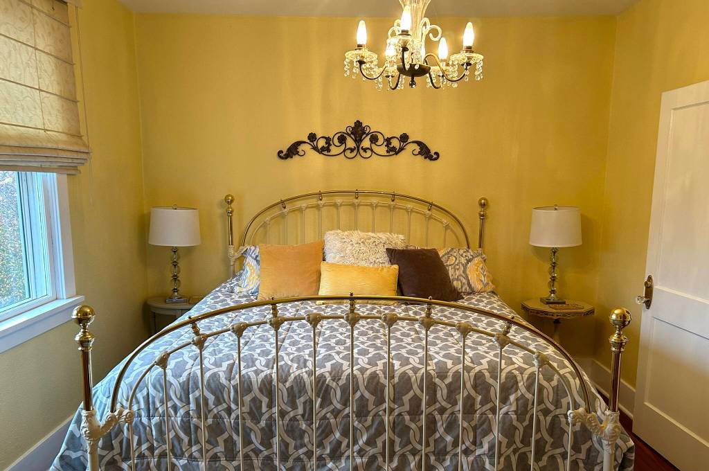 Sequim Gazette photo by Matthew Nash/ From this king-size bed in Sequim Heritage House, visitors can look into the yard and city streets.