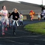 Sequim Gazette file photo by Matthew Nash/ Pals Evelyn Moore, left, and Averyonna Rowden skip along as they do laps together at the 2023 Turkey Trot. After reaching its goal last year for various programs between Greywolf and Helen Haller Elementary schools, Sequim Elementary PTA has set a goal of $28,000 to support similar efforts.