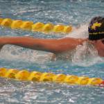 Photo courtesy Eric Ellefson/ Senior Melia Nelson propels herself forward at the West Central III 1A/2A district meet. She qualified for state with two relay teams.