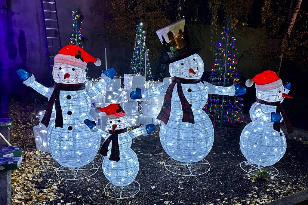 Photo courtesy Captain Crystal Stout/ This snowman family lights up in 1st Security Bank as part of volunteers efforts to decorate downtown Sequim.