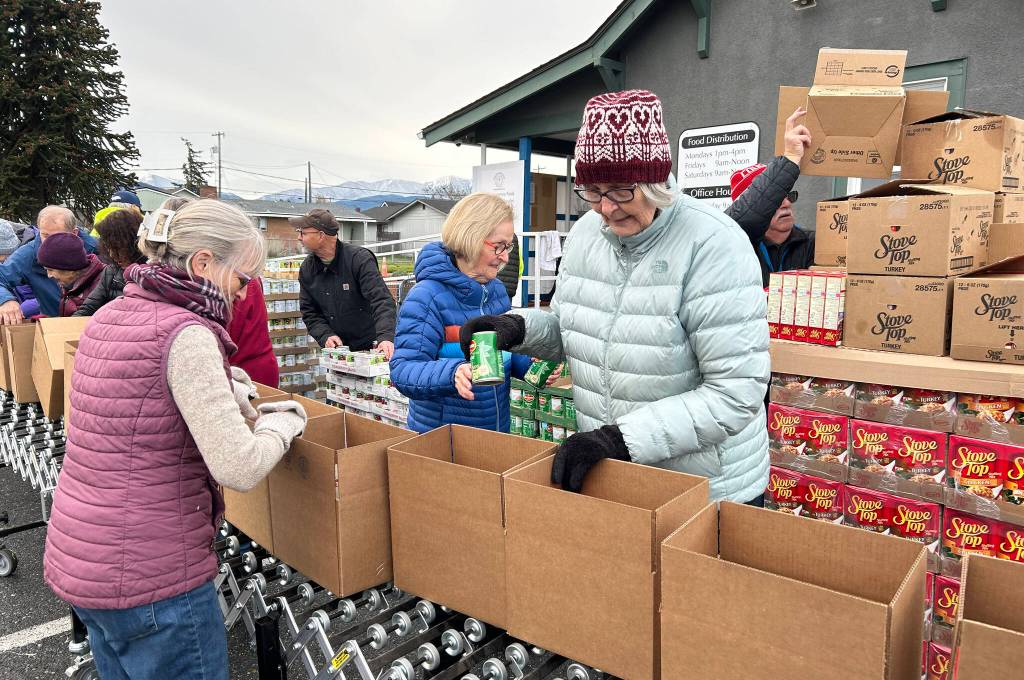 Sequim Gazette photo by Matthew Nash/ About 30 volunteers with the Sequim Seventh-day Adventist, or friends of church members, boxed up 1,200 Thanksgiving meals on Nov. 21.