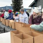 Sequim Gazette photo by Matthew Nash/ About 30 volunteers with the Sequim Seventh-day Adventist, or friends of church members, boxed up 1,200 Thanksgiving meals on Nov. 21.