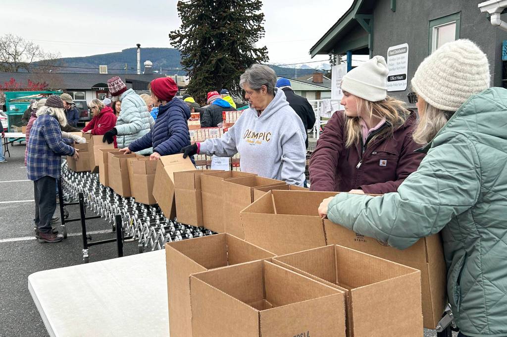Sequim Gazette photo by Matthew Nash/ About 30 volunteers with the Sequim Seventh-day Adventist, or friends of church members, boxed up 1,200 Thanksgiving meals on Nov. 21.