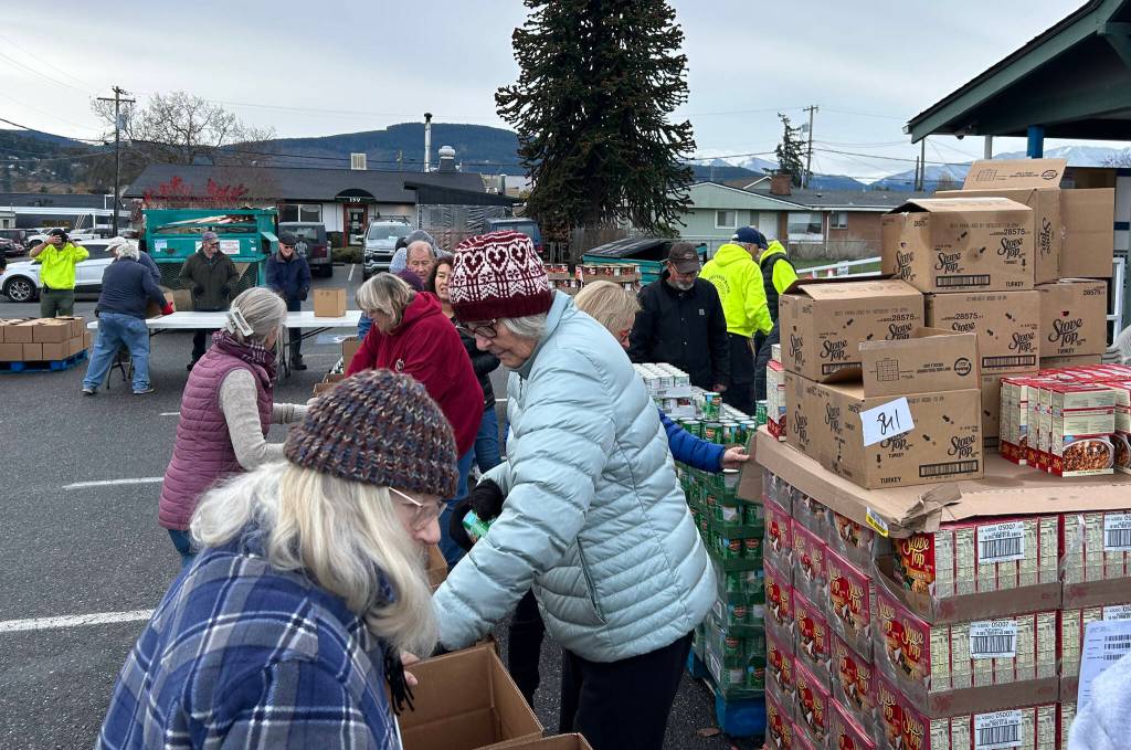 Sequim Gazette photo by Matthew Nash/ About 30 volunteers with the Sequim Seventh-day Adventist, or friends of church members, boxed up 1,200 Thanksgiving meals on Nov. 21.
