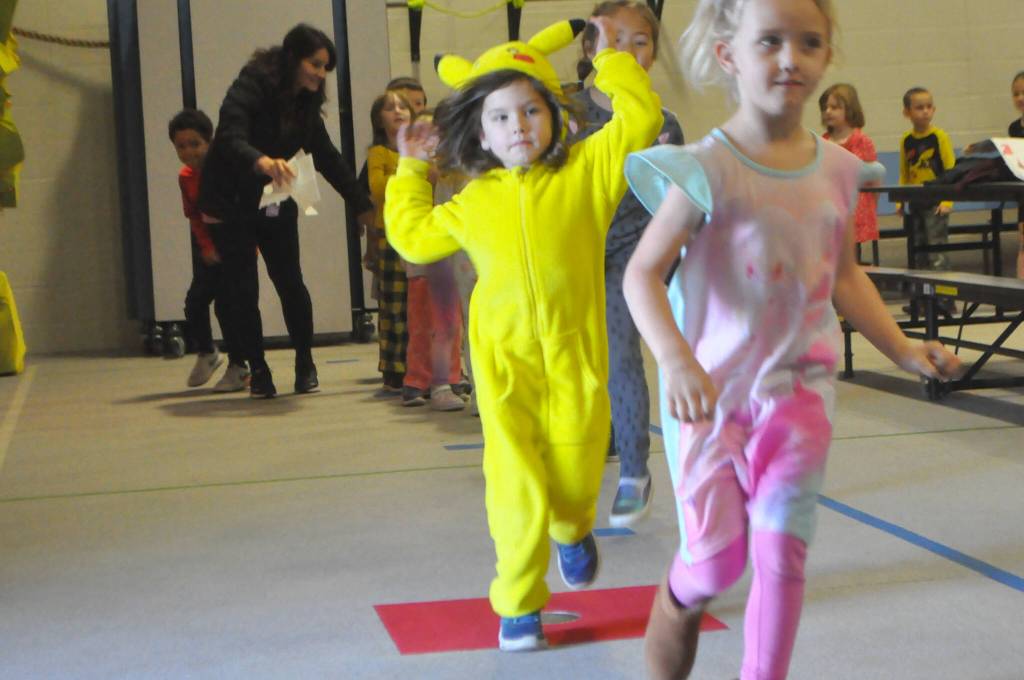 Sequim Gazette photo by Matthew Nash/ Ellis Roper, a kindergartener at Greywolf Elementary, runs a lap inside the schools gym dressed as Pikachu during the Nov. 27 Turkey Trot fundraiser.