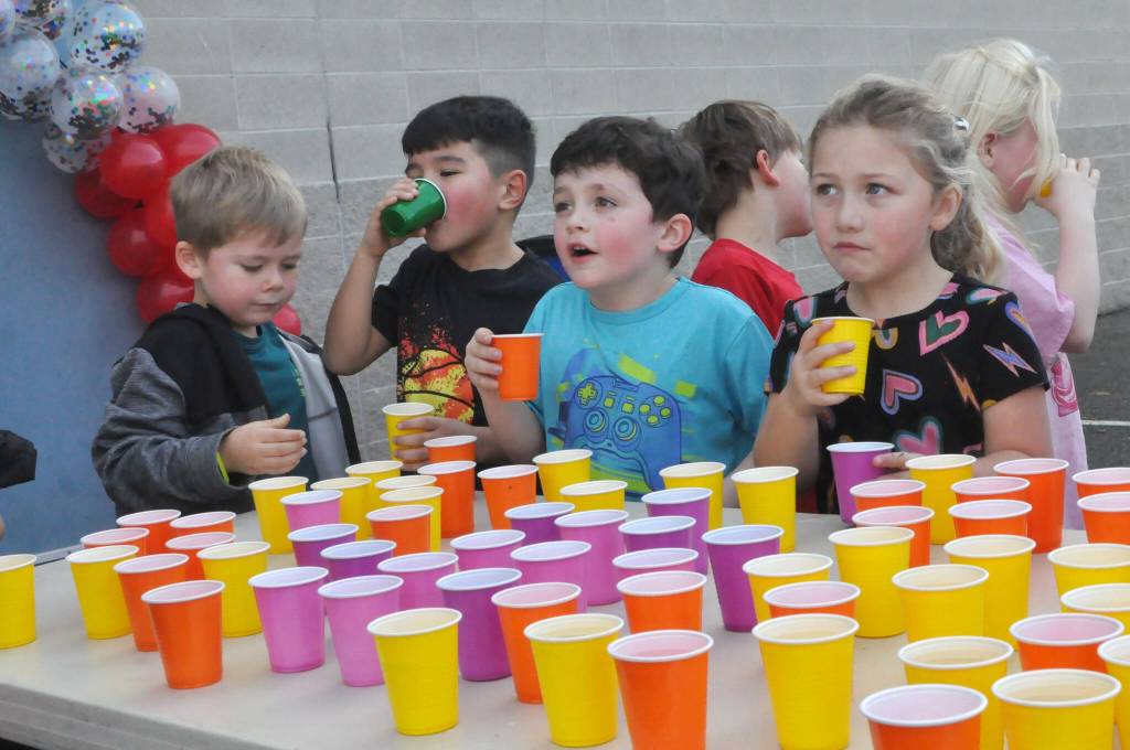Sequim Gazette photo by Matthew Nash/ Greywolf Elementary kindergarteners enjoy some well-deserved water after running laps for the Turkey Trot.
