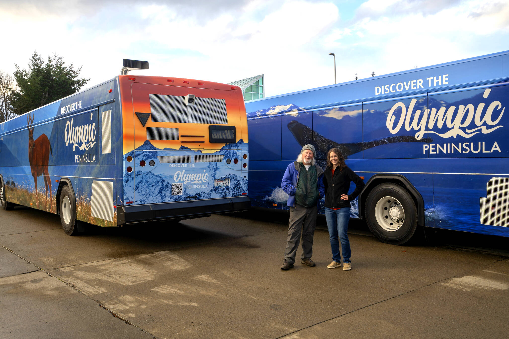 Photo by Paula Hunt, Olympic Peninsula News Group
Photographers John Gussman, left, and Becky Stinnett contributed their work to Clallam Transit Systems four wrapped buses that feature wildlife and landscapes on the Olympic Peninsula. The project was created to promote tourism and celebrate the beauty of the area.