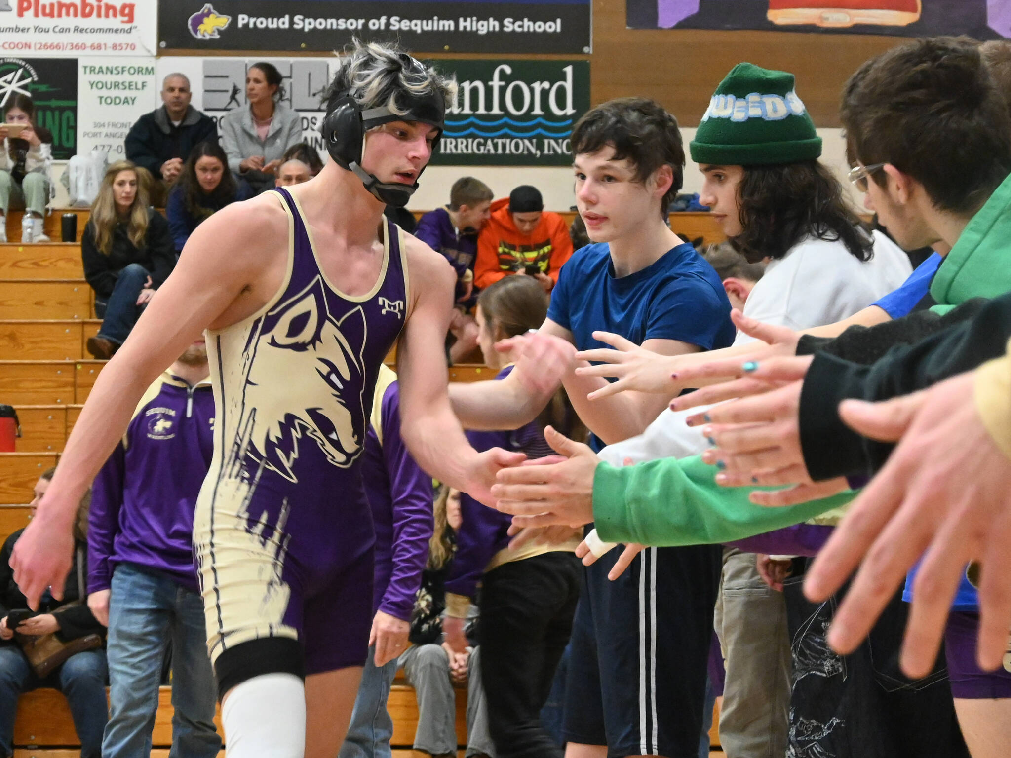 Sequim Gazette file photo by Michael Dashiell 
Sequims Jayms Vilona gets congratulated by teammates after a win over his Bremerton foe on Jan. 10. Hes one of the upperclassmen wrestlers anticipated to a make a continued leap forward, said new head coach Tyler Izatt.