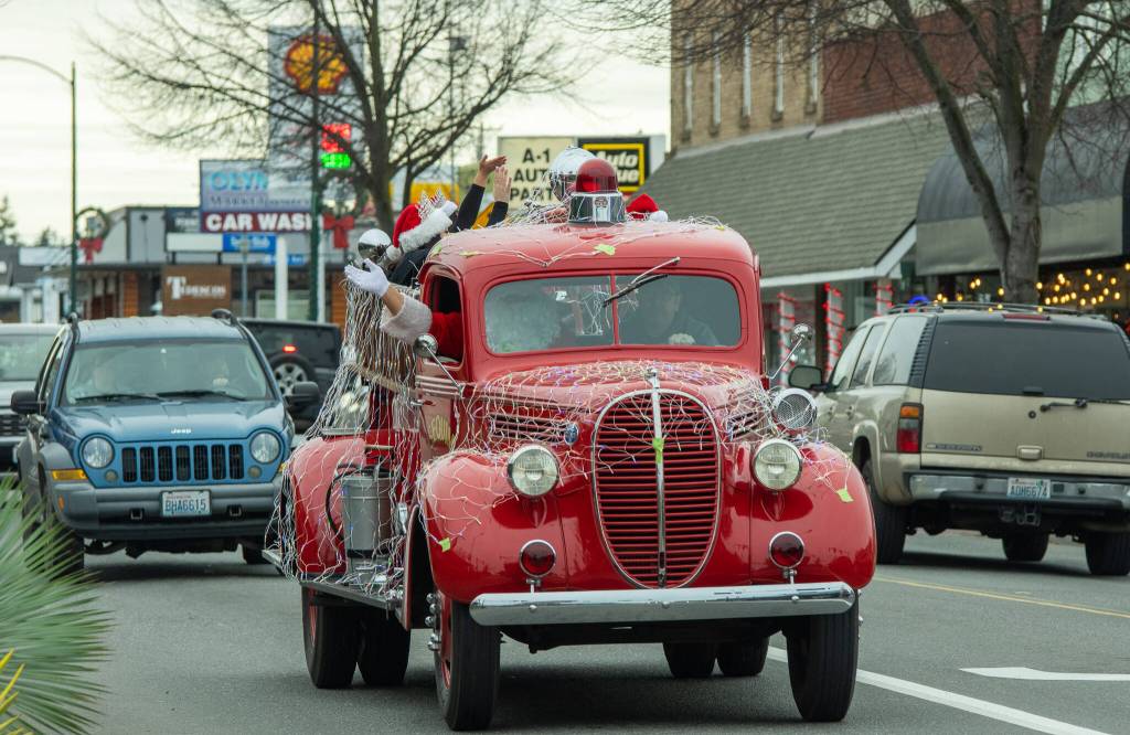 Sequim Gazette photo by Emily Matthiessen/ Santa's firetruck moves along with traffic.
