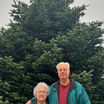Sequim Gazette photo by Matthew Nash/ Joel and Sharon Clark of Sequim stand with the downtown Christmas tree they donated to the City of Sequim for Centennial Place. God blessed me with it and I wanted to share it with so many other people, Sharon said.