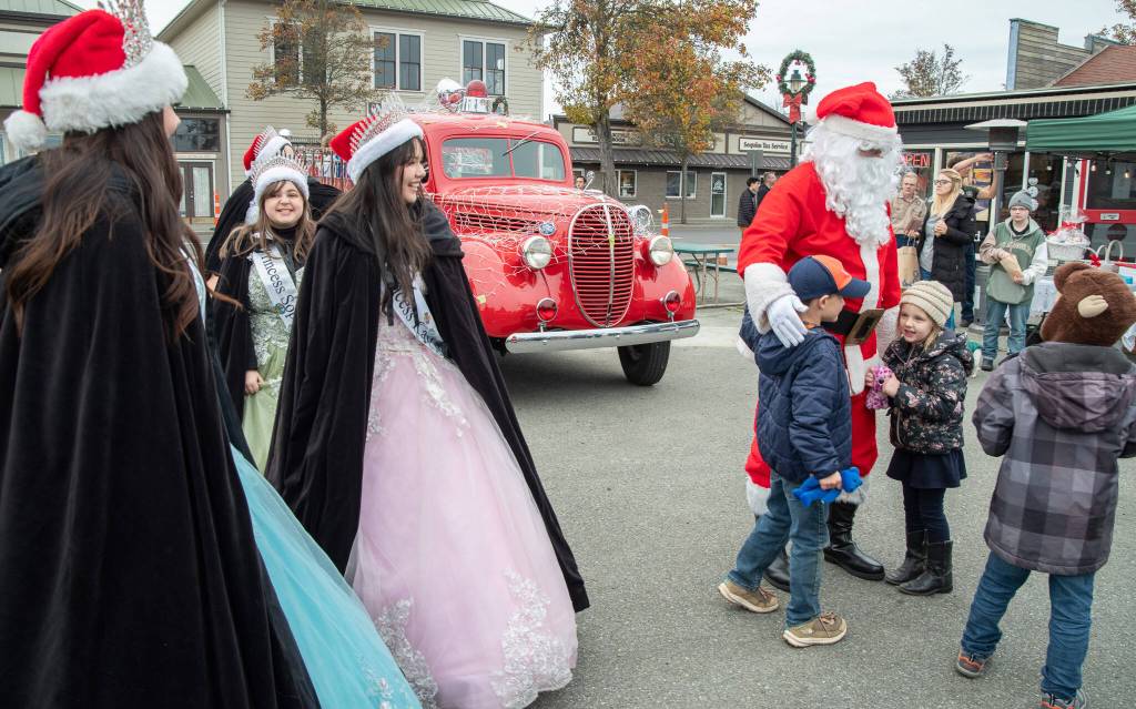 Sequim Gazette photo by Emily Matthiessen/ Sequim Irrigation Royalty and Santa Claus greet young fans at Hometown Holidays on Saturday.