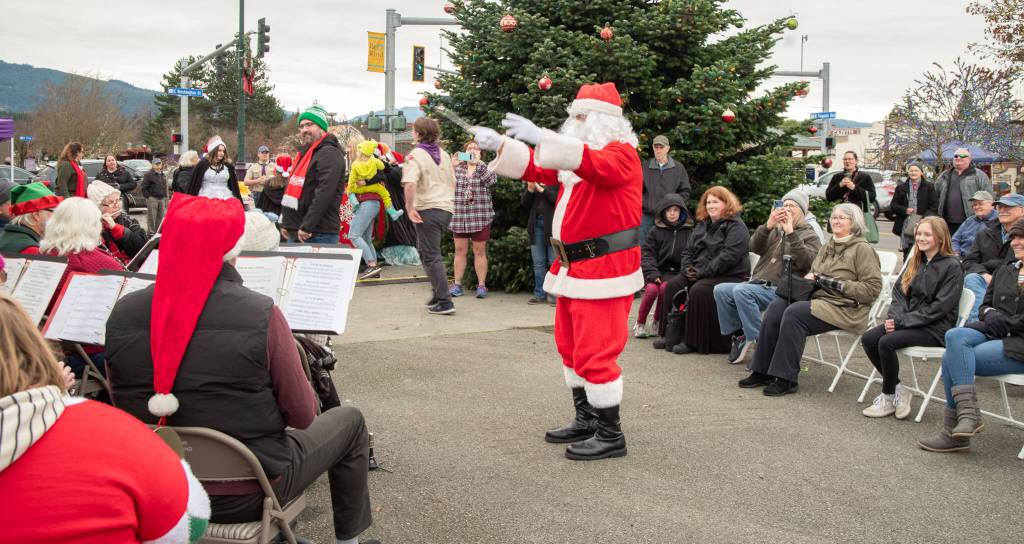 Sequim Gazette photos by Emily Matthiessen
Santa Claus treats townspeople to a display of his conducting skills while the Sequim City Band plays on at Hometown Holidays on Nov. 30.