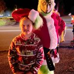 The Grinch (Brandon Tucker) meets 10-year-old Amelia Critchfield in Sunland on Dec. 5, during Santas Toy and Food Brigade. Amelia said shes taken photos with Santas Brigade the last three years.