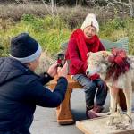 Photo courtesy Tim Shank
Hana Manaka has her photo taken with a wolf at the Holiday Nature Mart at the Dungeness River Nature Center on Nov. 24. Manaka recently celebrated turning 100, and volunteers gifted her items from the holiday fundraiser to help her celebrate.