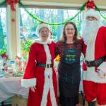 Sequim Gazette photo by Emily Matthiessen
Santa and Mrs. Claus (played by Ellen and John Castleman) stand with Della LaCour, who originated the idea to bring back the Sequim Prairie Garden Clubs tea event on Dec. 7. She said that when members of the club were going through old scrapbooks upon their 75th anniversary last year, we came across pictures of the tea, and they would like to make it a tradition going forward.