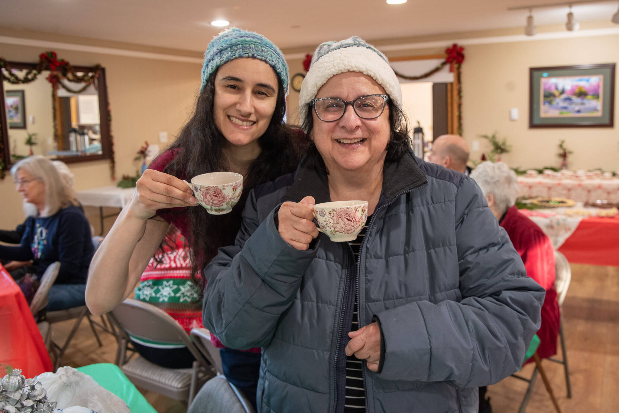 Sequim Gazette photo by Emily Matthiessen/ Daughter Claire Muggia, left, and mother Paula Muggia made a special effort to find a holiday tea and come out to Sequim from Port Angeles for the Sequim Prairie Garden Clubs first annual tea last Saturday. (Its) very welcoming, said Paula Muggia. They really created a wonderful atmosphere. The warm spirit of Christmas encapsulated in a cup of tea.