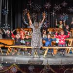 Sequim Gazette photo by Emily Matthiessen/ Five Acre School, a local non-profit elementary school, held their Winter Concert last Friday at Peninsula College under the direction of music and art teacher Rosie Sharpe. The children made the giant decorative wooden snowflakes.
