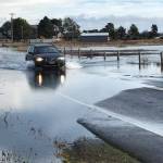 Photo courtesy Ian Hamilton
A car makes it way through high water on 3 Crabs Road on Dec. 14 following high tides that pushed water into the road.