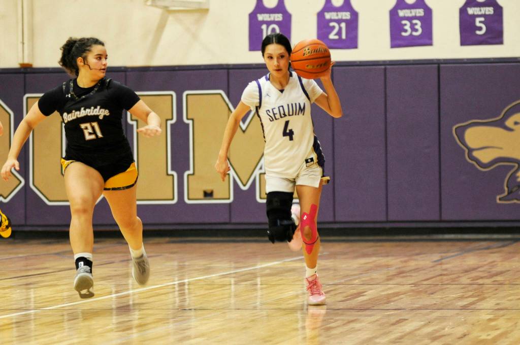Sequim Gazette photo by Matthew Nash/ Gracie Chartraw drives up court on Dec. 13 against Bainbridge.