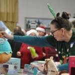 Sequim Gazette photo by Matthew Nash/ First-time volunteer Charlie Buckley of Sequim helps sort a Squishmallows plush toy during Toys for Sequim Kids. She learned about the event on Facebook and wanted to help, Buckley said.