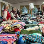 Sequim Gazette photo by Matthew Nash/ Hundreds of quilts and blankets were made by volunteers with Project Linus and Sunbonnet Sue Quilt Club for Toys for Sequim Kids. Blue Sky Realty also collected blankets and coats for the event.