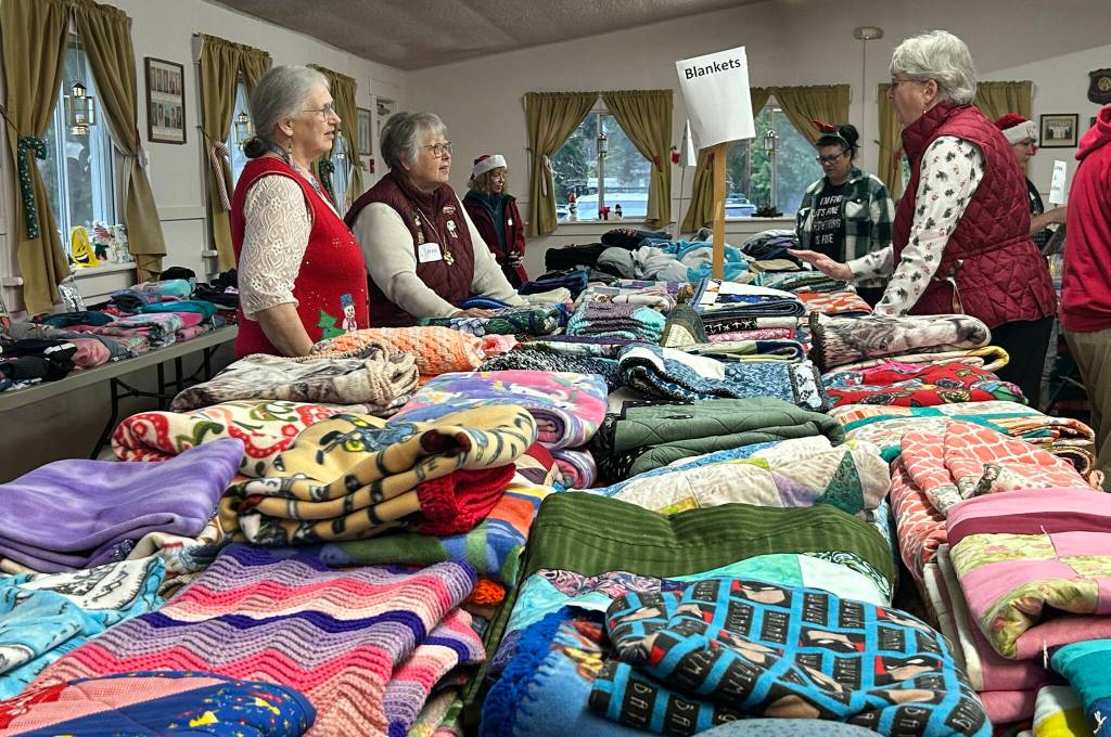 Sequim Gazette photo by Matthew Nash/ Hundreds of quilts and blankets were made by volunteers with Project Linus and Sunbonnet Sue Quilt Club for Toys for Sequim Kids. Blue Sky Realty also collected blankets and coats for the event.