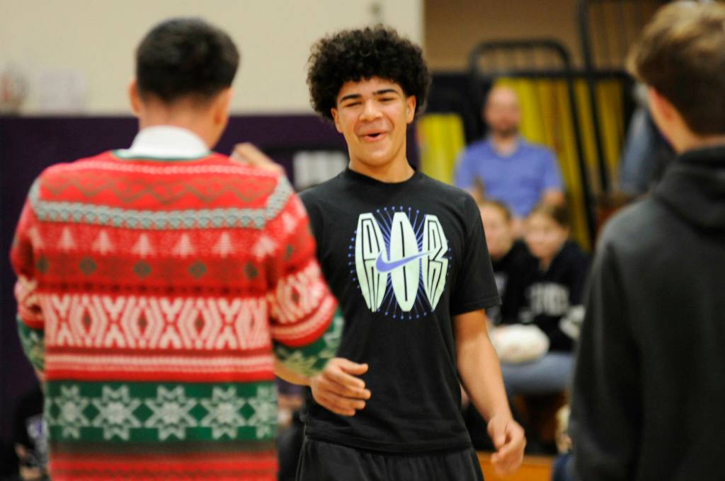 Sequim Gazette photo by Matthew Nash/ Sophomore Jericho Julmist learns on Dec. 18 at the annual Sequim High School Winter Wishes assembly he was given drivers education courses. He and 200-plus students received gifts courtesy the community and school staff.