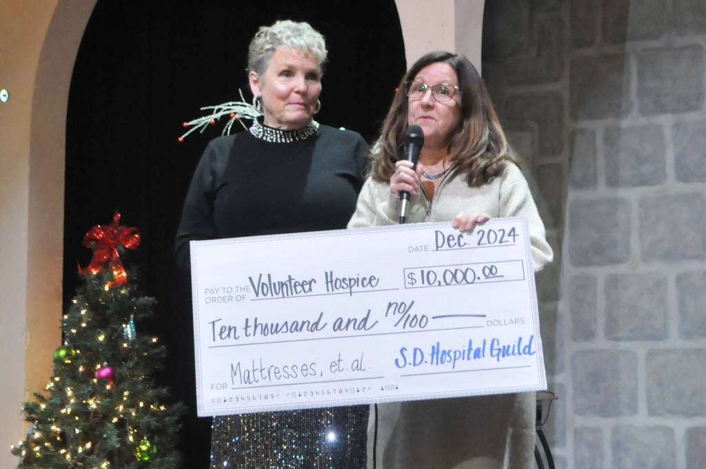 Sequim Gazette photo by Matthew Nash/ Lisa Palermo, development director for Volunteer Hospice of Clallam County, accepts a $10,000 check from Sequim-Dungeness Hospital Guild president Deborah Carlson to purchase new mattresses, hospital beds, and other needed medical supplies.
