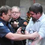 Sequim Gazette photo by Matthew Nash/ Community paramedic Mark Karjalainen with Clallam County Fire District 3 demonstrates on Dr. Paul Craven, medical program director, how a new ultrasound machine will help him in the field. Holding a microphone is Fire Chief Justin Grider for the Sequim-Dungeness Hospital Guild who donated $10,000 for the device and training.