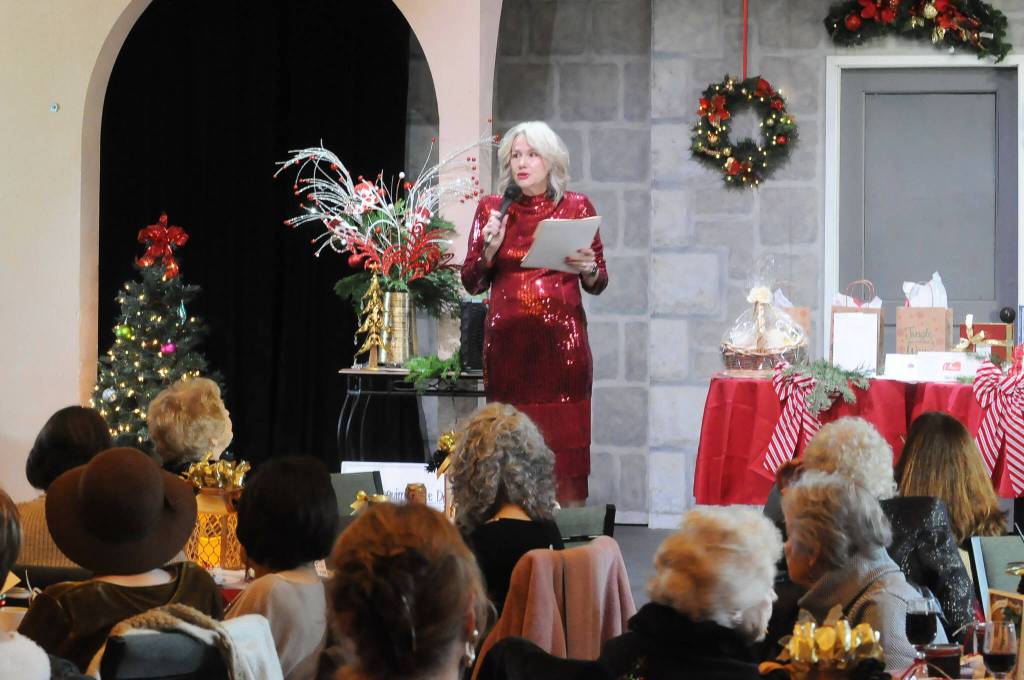 Sequim Gazette photo by Matthew Nash/ Sandra Berryhill-Huish, vice-president of the Sequim-Dungeness Hospital Guild board, thanks Thrift Shop volunteers at the groups annual luncheon on Dec. 13 in Olympic Theatre Arts.