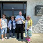 Photo courtesy of Shipley Center / Eileen Schmitz, JACE Real Estate owner and Shipley Center board member, presents the keys of the former JCPenney building at 651 W. Washington St. to Shipley Center executive director Michael Smith following the centers Aug. 8 purchase of the building. At far left is Joyce Gladen of JACE Real Estate, and second from left is Shipley Center board secretary Margaret Cox.