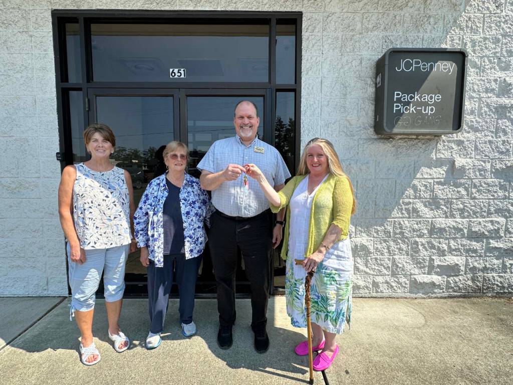 Photo courtesy of Shipley Center / Eileen Schmitz, JACE Real Estate owner and Shipley Center board member, presents the keys of the former JCPenney building at 651 W. Washington St. to Shipley Center executive director Michael Smith following the centers Aug. 8 purchase of the building. At far left is Joyce Gladen of JACE Real Estate, and second from left is Shipley Center board secretary Margaret Cox.