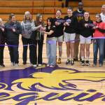 Sequim Gazette photo by Michel Dashiell 
Sequim High School athletes, students and coaches, along with representatives from the Sequim-Dungeness Valley Chamber of Commerce, celebrate the schools newly-refurbished floor inside the Rick Kaps Gymnasium with a ribbon-cutting prior to a basketball doubleheader on Jan. 20. The floor was paid for by voters who approved a four-year, $15 million capital projects levy in February 2021.