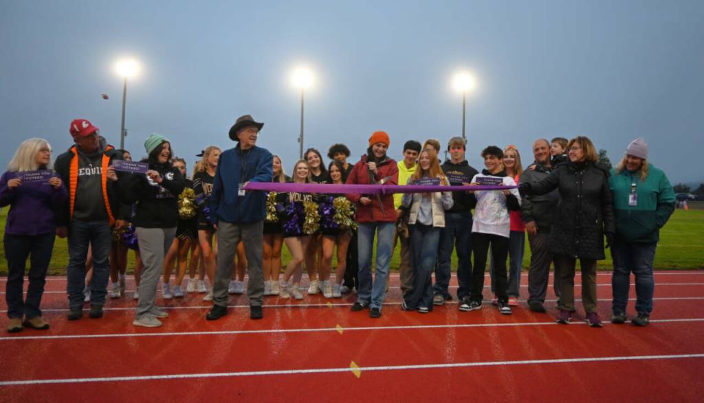 Sequim Gazette photo by Michael Dashiell / Sequim High sophomore Clare Turella does the honors, cutting a ceremonial ribbon to celebrate the Sequim School Districts newly-refurbished track on Sept. 13. Turella won a state 2A high jump title as a freshman in 2023.