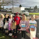 Photo courtesy Darcy Lamb 
Greywolf Elementary first graders in Rachel Peck and Cricket Hagans class, from left, Lucas Kroh, Dakota Joslyn-Crass, Oliver Vargas, Ruby Miller, Logan Tinkham, Autumn Glen, and Freya Welch stand with donations to Sequim Food Bank for 12 Days of Giving. School leaders said each class won an extra recess at least once for donating the most items each day.