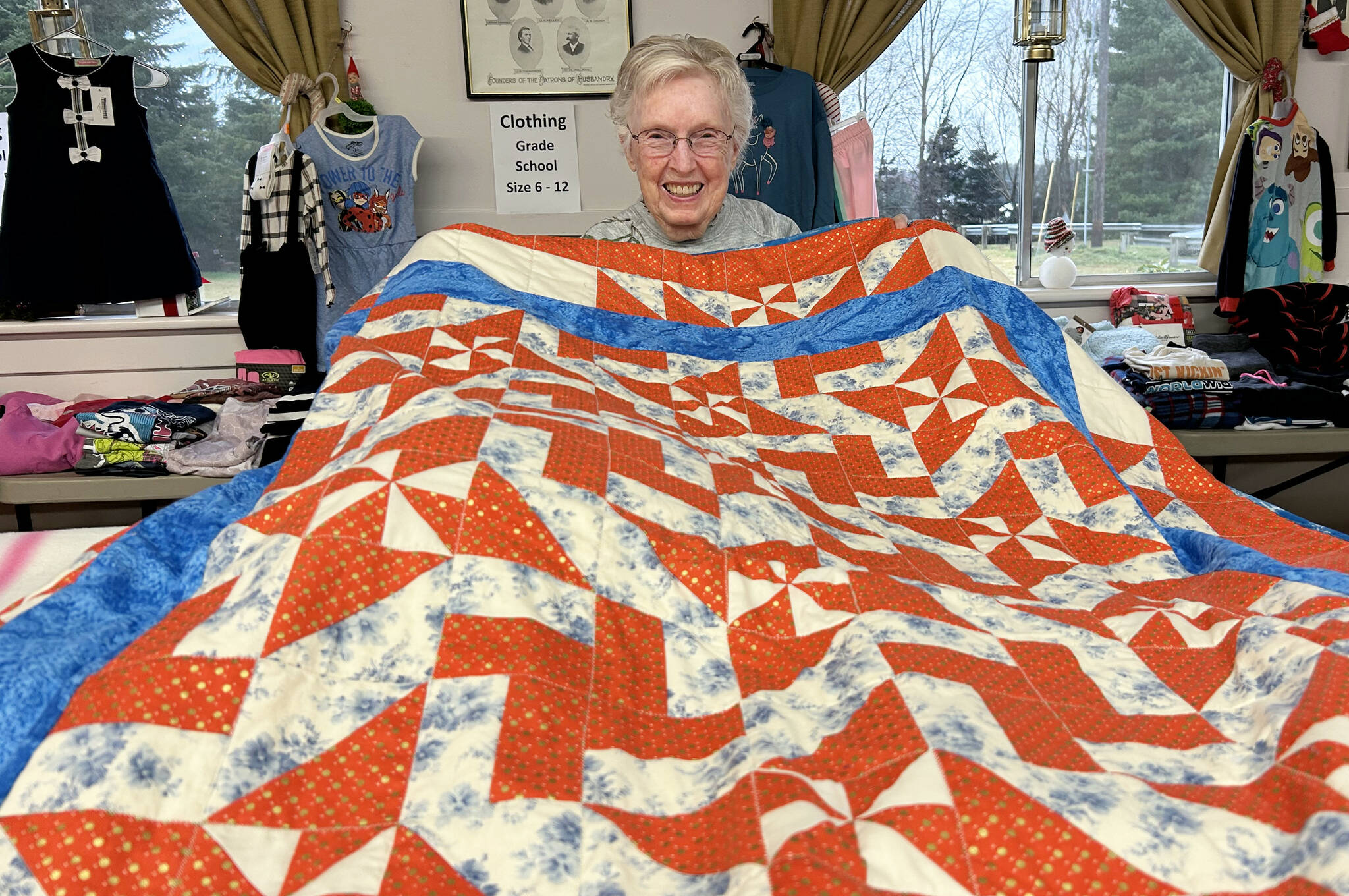 Sequim Gazette photo by Matthew Nash
LaRue Robirts shows one of the quilts she made for Toys for Sequim Kids on Dec. 17 in Sequim Prairie Grange. By her count, shes made and donated more than 1,400 quilts to community efforts.