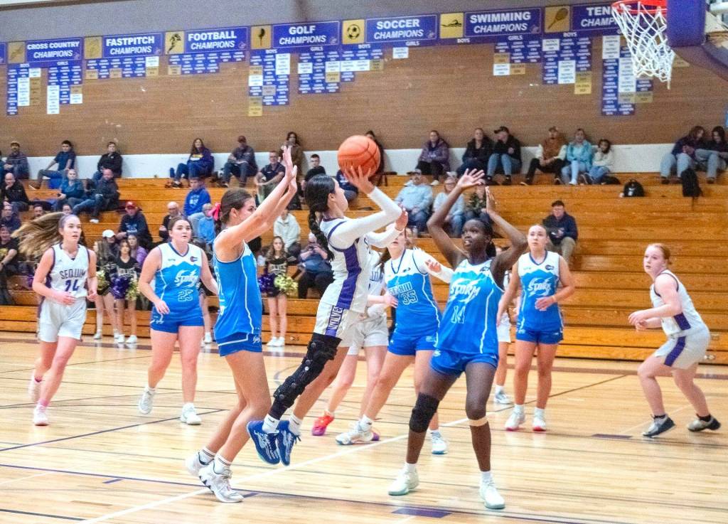 Sequim Gazette photo by Emily Matthiessen
Sequims Gracie Chartraw leans in to shoot over Bellarine Storm select players from Australia on Dec. 30.