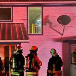 Sequim Gazette file photo by Matthew Nash
Firefighters with Clallam County Fire District 3 determine a course of action last year on March 21 at a garage/house fire to prevent flames going from the attic into the remainder of the home. Calls to 911 for fires were down in 2024.