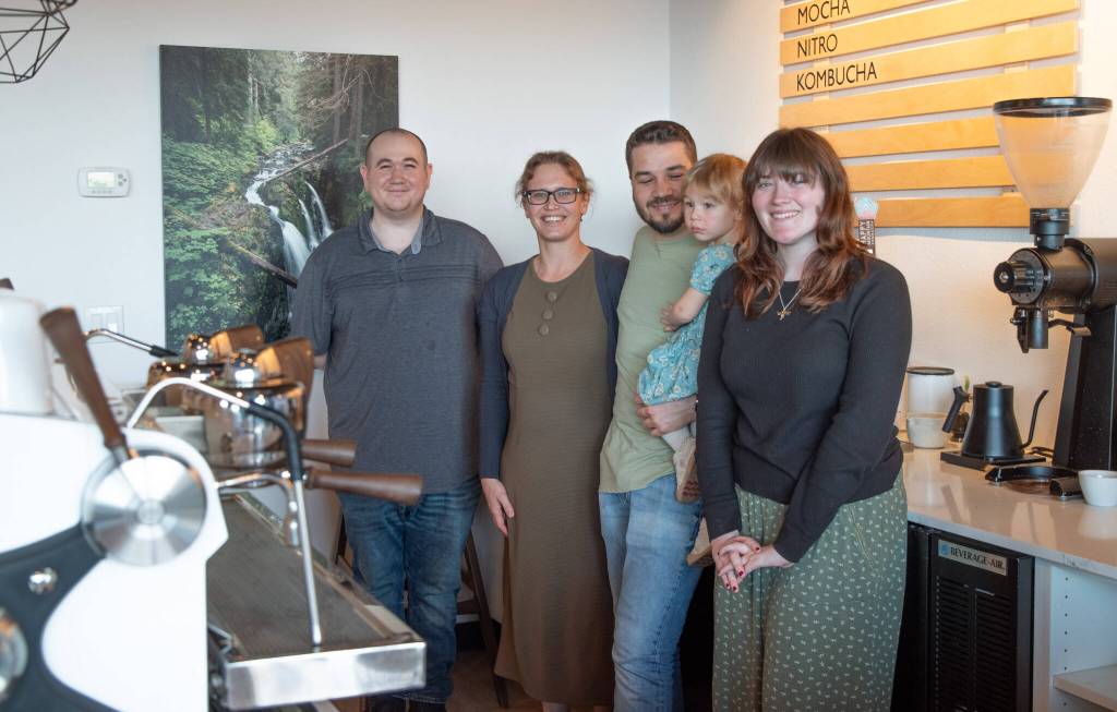 Sequim Gazette photo by Emily Matthiessen/ Megan and Rod Dirks, second and third from left, are thankful that their three baristas are keeping Essence Coffee Roasters going while they spend weekdays this month in Seattle so that Rod can receive radiation treatments for a rare form of cancer. Shown here are baristas Zane Haden (far left) and Ava Fuller. Barista Zach Bulman is not shown.