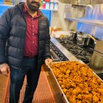 Sequim Gazette photo by Kathy Cruz 
Harinderbir Nagra, co-owner of Hardys Market, shows off a tray of onion bhaji, onion fritters seasoned with ginger and spices, as the store prepared to launch its new Indian food takeout menu last week.