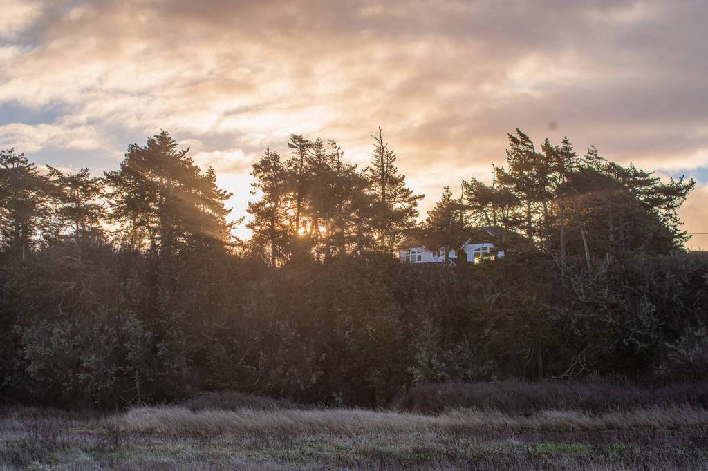 Sequim Gazette photo by Emily Matthiessen/ The sun peeks through the clouds opposite to where it causes a partial rainbow on Fri. Jan. 10.