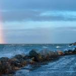 Sequim Gazette photo by Emily Matthiessen
Waves splashed into the parking lot and a rainbow appeared during a burst of stormy weather earlier this month at Cline Spit.