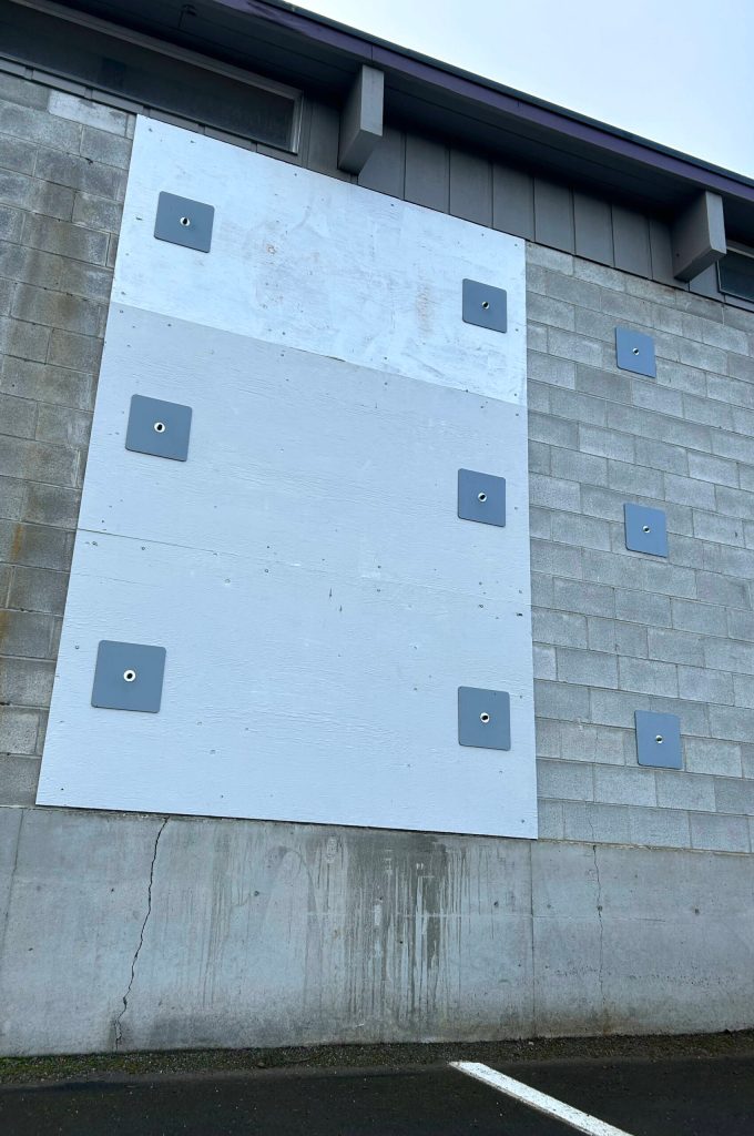 Sequim Gazette photo by Matthew Nash
This plywood sheet was placed on the Transportation Centers repair shops north side wall a few years ago to prevent it from deteriorating more. However, Sequim School District staff said the wall continues to crack and there is a growing gap between the wall and floor due to water infiltration underneath the building.