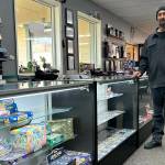 Sequim Gazette photo by Matthew Nash
Douglas Offenheiser, co-owner of Cardquest Gaming, stands by glass cases that a burglar cleaned out in December. Offenheiser estimates about $30,000 in cards from various games were stolen.