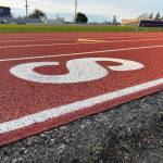 Sequim Gazette photo by Matthew Nash/ While the track was resurfaced this summer so that students could host track meets again, Sequim School District officials said it went 20 years past its lifespan and its dimensions are incorrect and in order to fix that they must move the stadium and power poles.