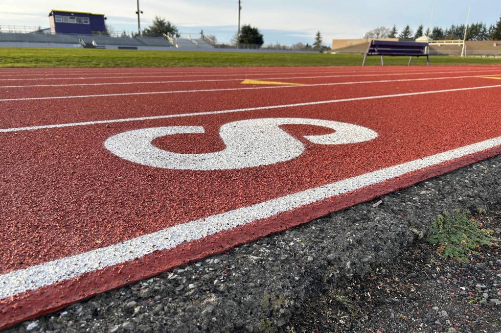 Sequim Gazette photo by Matthew Nash/ While the track was resurfaced this summer so that students could host track meets again, Sequim School District officials said it went 20 years past its lifespan and its dimensions are incorrect and in order to fix that they must move the stadium and power poles.