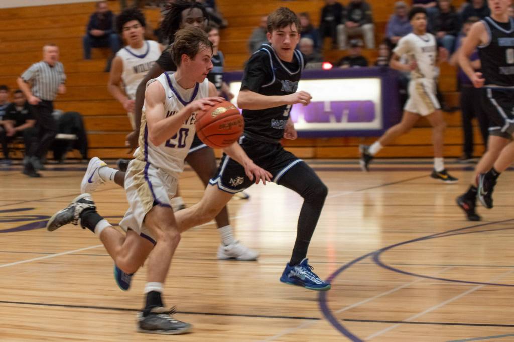 Sequim Gazette photo by Emily Matthiessen/ Mason Rapelje races up the court past North Mason players on Jan. 21.
