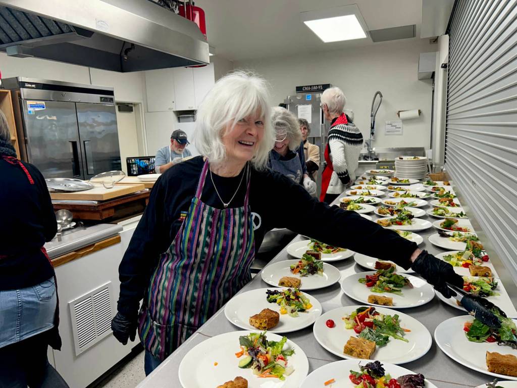 Sequim Gazette photo by Kathy Cruz/ Mary Montgomery-Crumley dishes up helpings of salad at Soups On. Lunch also included a biscuit, two versions of minestrone soup - one vegetarian, one with chicken - and Chocolate Chip Butterscotch Bars.
